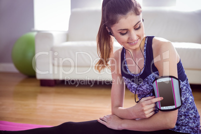 Fit woman stretching on exercise mat