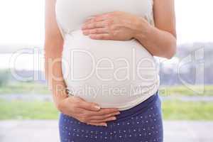 Pregnant woman holding her bump