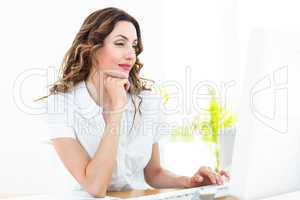 Smiling businesswoman working with her computer