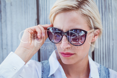 Pretty blonde woman wearing sun glasses