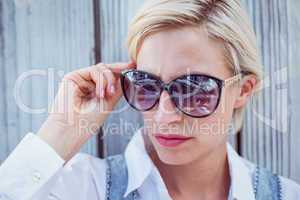 Pretty blonde woman wearing sun glasses