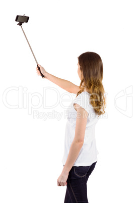 Pretty woman using a selfie stick