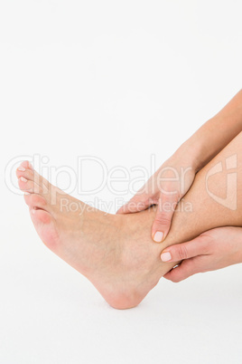 Woman touching her painful ankle
