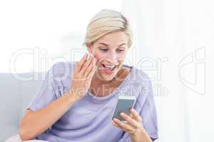 Pretty blonde woman texting with her mobile phone