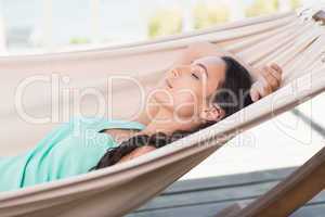 Pretty brunette relaxing on a hammock