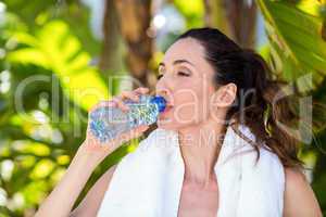 Beautiful brunette drinking water