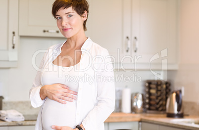 Pregnant woman smiling at camera