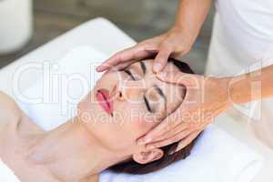 Brunette receiving head massage