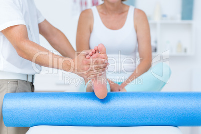 Doctor examining his patients leg