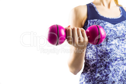 Fit woman lifting pink dumbbell