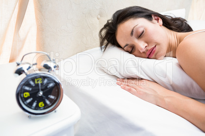 Pretty brunette sleeping on bed