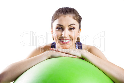 Fit woman leaning on exercise ball