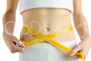 Slim woman measuring her waist