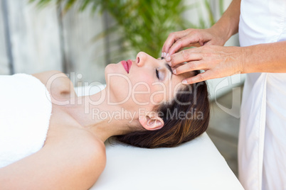 Brunette receiving head massage