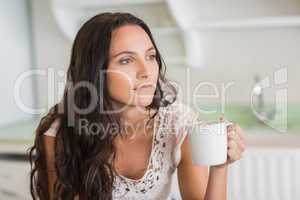 Pretty brunette holding a mug