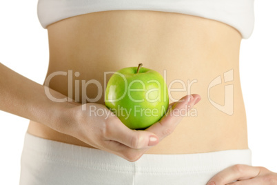 Slim woman holding green apple