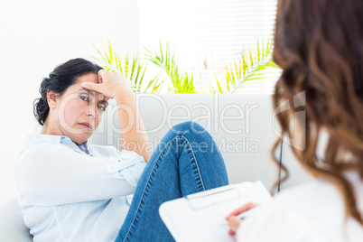 Therapist listening her patient and taking notes