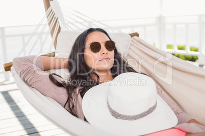 Pretty brunette relaxing on a hammock