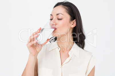 Pretty brunette drinking water