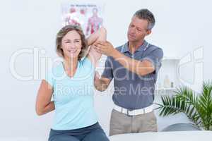 Woman stretching her arms with her doctor