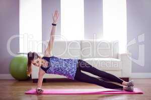 Fit woman doing side plank