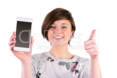 Pretty brunette holding her smartphone and looking at camera