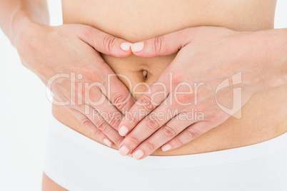 Fit woman with hands on her stomach