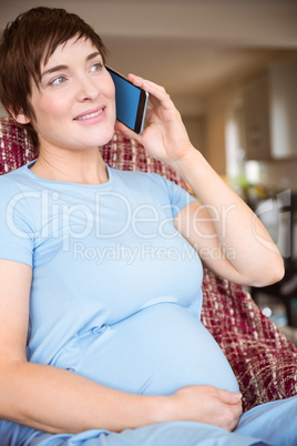 Pregnant woman making a call