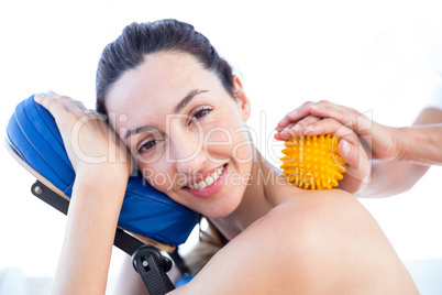 Woman having back massage with massage ball