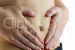 Slim woman touching her belly