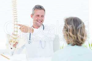 Doctor showing his patient a spine model