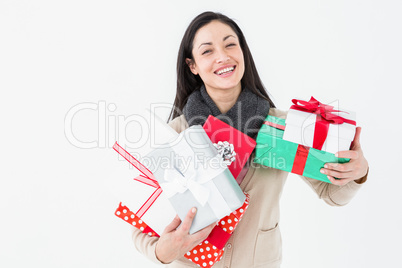 Happy brunette holding gifts