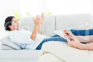 Therapist listening her patient and taking notes