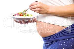 Pregnant woman eating a salad