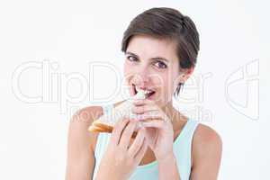 Happy brunette eating sandwich