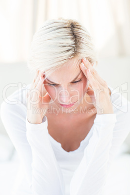 Blonde woman having headache