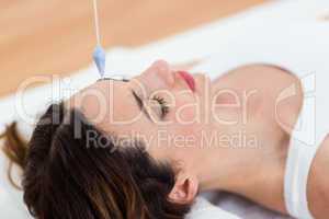 Woman being hypnotized while lying on the floor