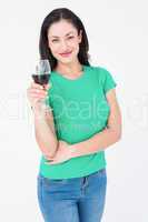 Smiling brunette holding glass of red wine