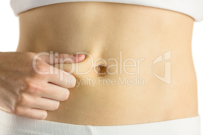 Slim woman pinching her belly