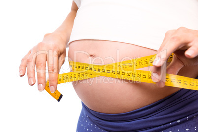 Pregnant woman measuring her bump