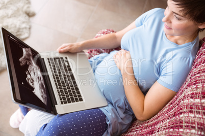 Pregnant woman using her laptop