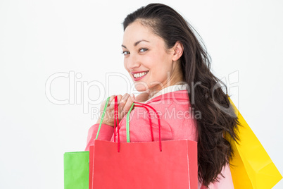 Smiling brunette holding shopping bags