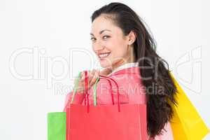 Smiling brunette holding shopping bags