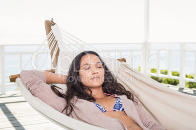 Pretty brunette relaxing on a hammock