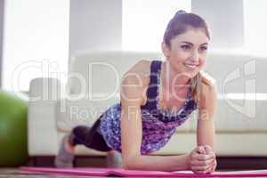 Fit woman planking on exercise mat