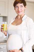 Pregnant woman having a glass of orange juice