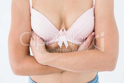 Woman in bra with breast cancer awareness ribbon
