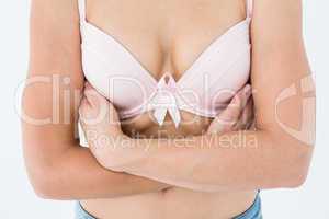 Woman in bra with breast cancer awareness ribbon