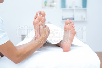 Physiotherapist doing foot massage