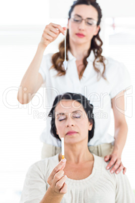 Woman being hypnotized to quit smoking